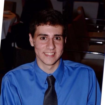 Headshot: Craig in a blue shirt and black tie