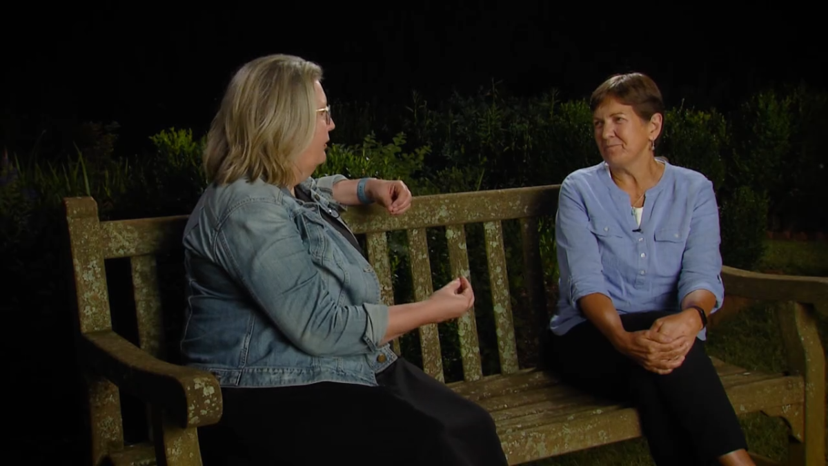 Kelsey Johnson sitting on a bench speaking to the host